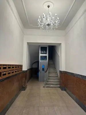 a hallway with a staircase with a chandelier at 753 Roma in Rome