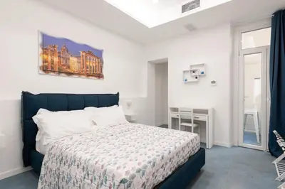 a bedroom with a bed and a table and a window at 753 Roma in Rome