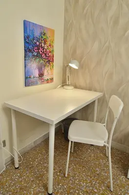 a white desk with a lamp and a chair at The Sunny House of Rome in Rome