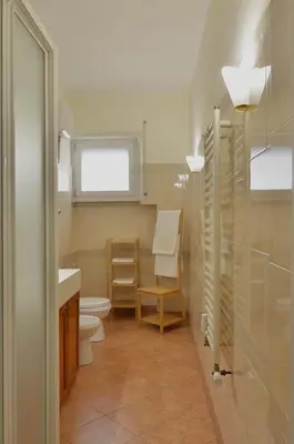 a bathroom with a toilet and a sink at The Sunny House of Rome in Rome