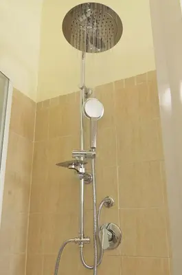 a shower with a shower head in a bathroom at The Sunny House of Rome in Rome