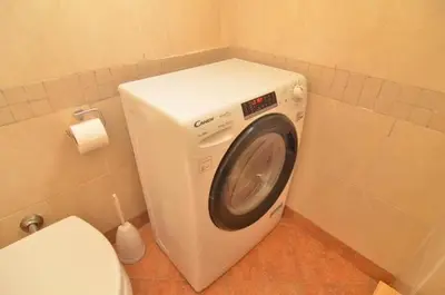 a washing machine in a bathroom next to a toilet at The Sunny House of Rome in Rome