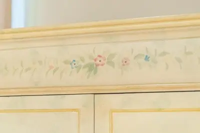 a wooden cabinet with flowers painted on it at Secret Luxury Retreat in the Heart of the Ghetto by Houseeds in Rome