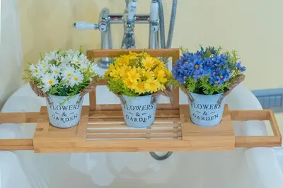 three potted flowers on a shelf in a bathroom at Secret Luxury Retreat in the Heart of the Ghetto by Houseeds in Rome