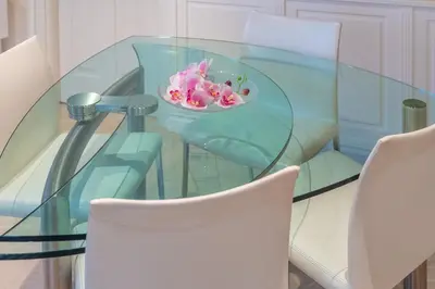 a glass table with a bowl of pink flowers on it at Secret Luxury Retreat in the Heart of the Ghetto by Houseeds in Rome