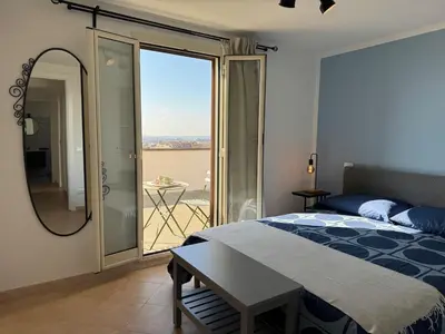 a bedroom with a bed and a view of the ocean at Rooftop via Appia Nuova, Roma in Rome