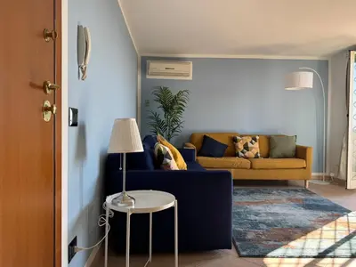 a living room with a couch and a table at Rooftop via Appia Nuova, Roma in Rome