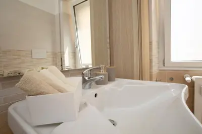 a bathroom with a white sink and a mirror at CaSa e Caffarella in Rome