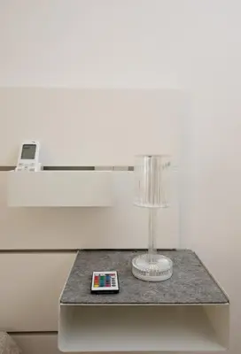 a table with a wine glass and a remote control at CaSa e Caffarella in Rome