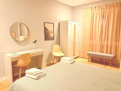 a bedroom with a bed and a desk and a mirror at Casa Vacanze Leone in Rome