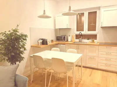 a kitchen with a white table and chairs in it at Casa Vacanze Leone in Rome