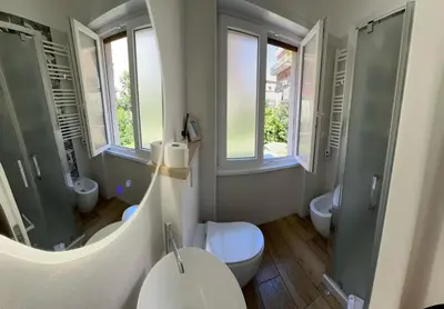 a bathroom with two sinks and a mirror at Casa Vacanze Leone in Rome