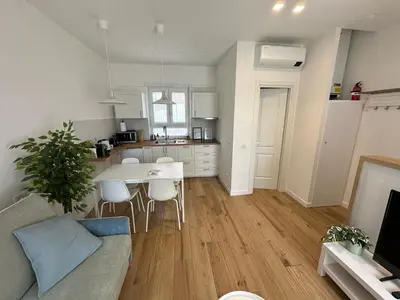 a kitchen and living room with a table and chairs at Casa Vacanze Leone in Rome