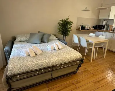 a bedroom with a bed and a table with chairs at Casa Vacanze Leone in Rome