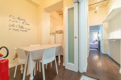 a dining room with a table and chairs at Family Retreat in the Heart of the Ghetto by Houseeds in Rome