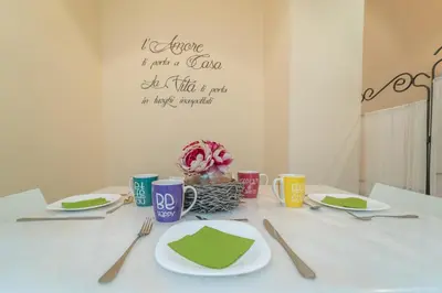 a white table with plates and utensils on it at Family Retreat in the Heart of the Ghetto by Houseeds in Rome