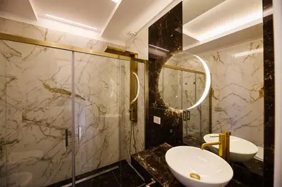 a bathroom with a sink and a glass shower at Residenza Alferini - San Pietro in Rome