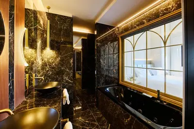 a bathroom with a tub and a sink and a window at Residenza Alferini - San Pietro in Rome