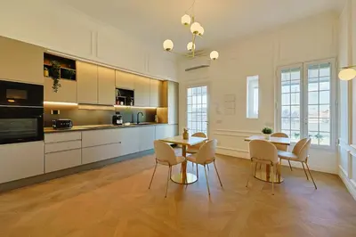 a kitchen and dining room with a table and chairs at Residenza Alferini - San Pietro in Rome