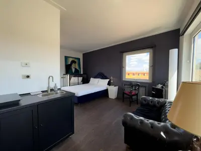 a hotel room with a bed and a couch and a sink at Chasing the Stars Spanish Steps Boutique Suite in Rome