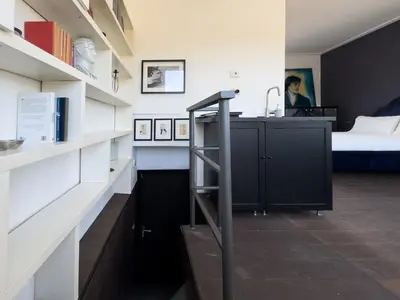 a room with a staircase leading to a bedroom at Chasing the Stars Spanish Steps Boutique Suite in Rome