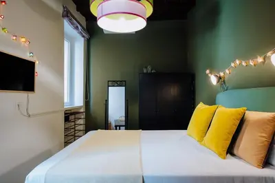 a bedroom with a large white bed with yellow pillows at Navona Boutique Apartment with terrace in Rome