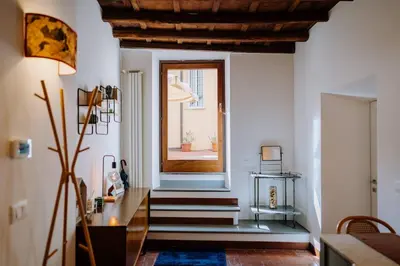 a living room with stairs and a window at Navona Boutique Apartment with terrace in Rome