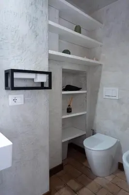 a white bathroom with a toilet and a sink at Navona Boutique Apartment with terrace in Rome
