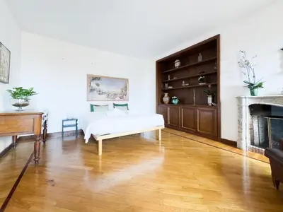 a living room with a white couch and a fireplace at Maison Giulia in Rome