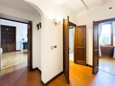 an open hallway with doors to a living room at Maison Giulia in Rome