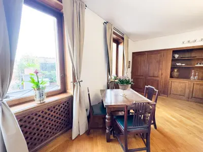 a dining room with a table and a window at Maison Giulia in Rome