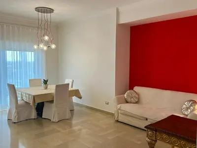 a living room with a table and a couch at Green house - appartamento rome in Rome