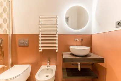 a bathroom with a sink and a toilet and a mirror at Domina Livia Vaticano Roma - Suite e Room in Rome