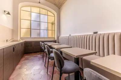 a row of tables in a restaurant with a window at Domina Livia Vaticano Roma - Suite e Room in Rome