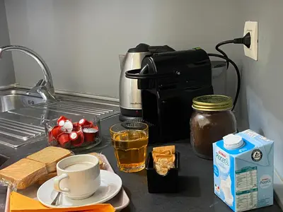 a kitchen counter with a coffee maker and some food at Domus Pacis in Rome