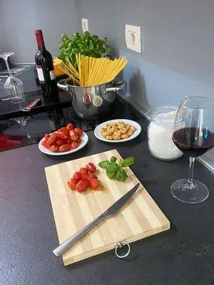 a counter with a cutting board and a glass of wine at Domus Pacis in Rome
