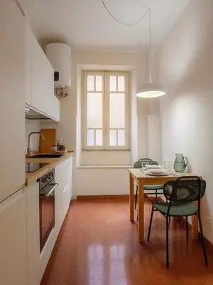 a kitchen with a table and chairs in a room at Labicana - Rome Apartment in Rome