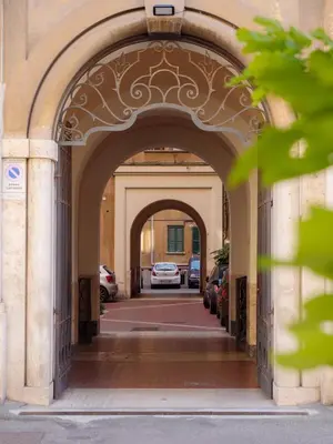 an archway in a building with cars parked at Labicana - Rome Apartment in Rome