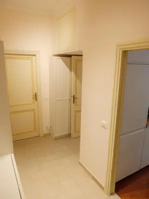 an empty room with two doors and a hallway at Labicana - Rome Apartment in Rome