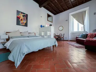 a bedroom with a large bed and a couch at Inn Pantheon Home in Rome