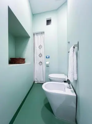 a bathroom with a white tub and a toilet at Inn Pantheon Home in Rome