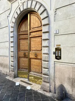 a wooden door in a building with an archway at Inn Pantheon Home in Rome