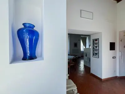 a blue vase is on a wall in a room at Inn Pantheon Home in Rome