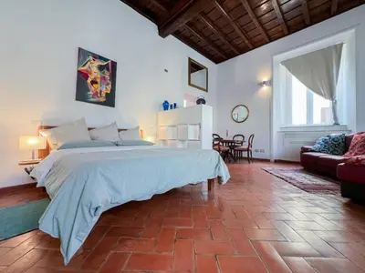 a bedroom with a large bed and a living room at Inn Pantheon Home in Rome