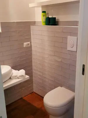 a bathroom with a white toilet and a sink at Suite Benedict Pantheon in Rome