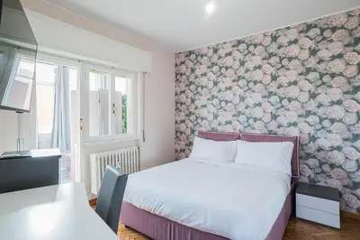 a bedroom with a bed and a floral wall at B&B Damagi in Rome