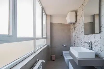 a bathroom with a sink and a toilet and a window at B&B Damagi in Rome