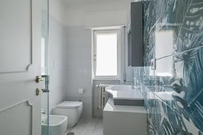 a white bathroom with a toilet and a sink at B&B Damagi in Rome