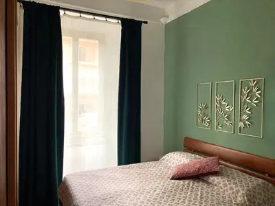a bedroom with a bed next to a window at Casa Ferrari in Rome