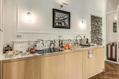 a kitchen with a counter top with fruits on it at Piazza Venezia Luxe Apartment in Rome